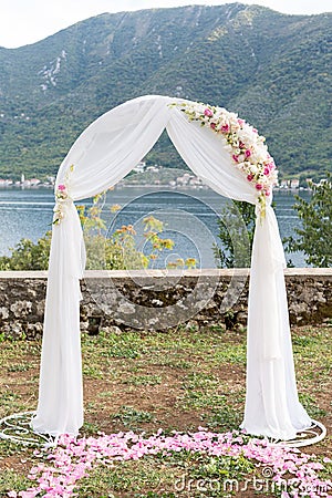 Wedding arch decorated with flowers outdoors Stock Photo