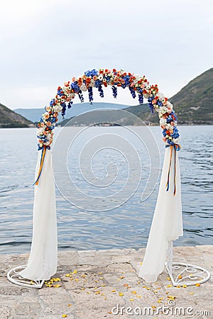Wedding arch decorated with flowers outdoors Stock Photo