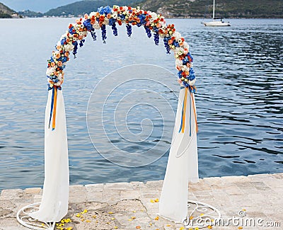 Wedding arch decorated with flowers outdoors Stock Photo