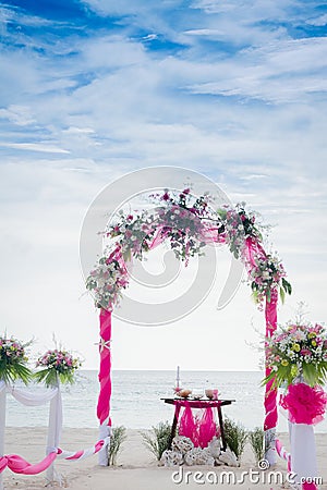 Wedding arch decorated with flowers on tropical beach, outd Stock Photo