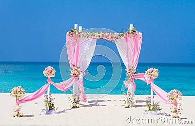 Wedding arch decorated with flowers on tropical beach, outd Stock Photo