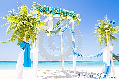 Wedding arch decorated with flowers on tropical beach, outd Stock Photo