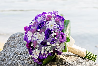 Wedding bouquet and rings. The bride`s bouquet on the stone. declaration of love. Wedding card, day details Stock Photo