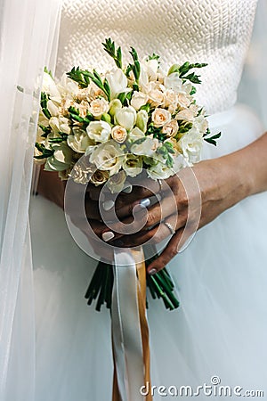 Wedding bouquet in bride`s hands. Bunch of small elegant flowers Stock Photo