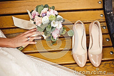 Wedding bouquet and bride shoes Stock Photo