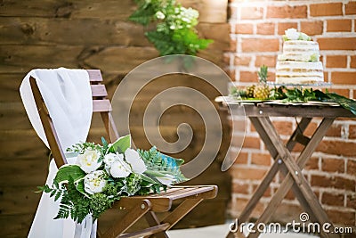 Wedding bouquet lying on wooden chair for wedding ceremony Stock Photo