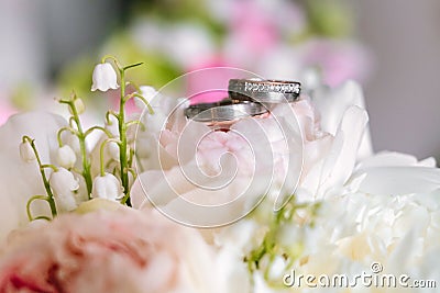 Wedding bouquet with rings on top from side view Stock Photo