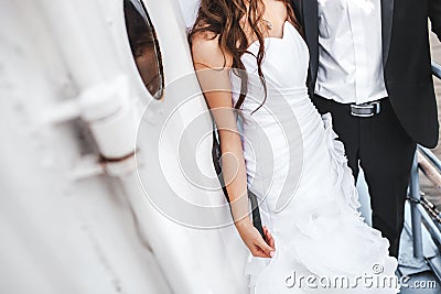 Wedding bride and groom on deck of boat, stylish couple. Stock Photo