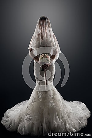 Wedding Bride in Veil on face, Elegant Lady in Luxury Bridal Dress, Studio Portrait Stock Photo