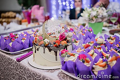 Wedding cake with a candy bar at a banquet Stock Photo