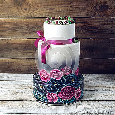 Wedding cake ornamented in rustic style blue and purple roses Stock Photo