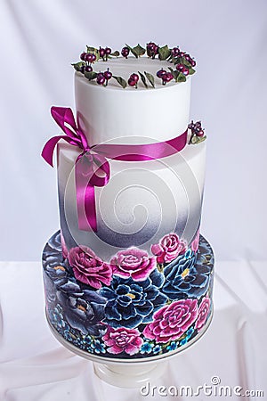 Wedding cake ornamented in rustic style blue and purple roses Stock Photo