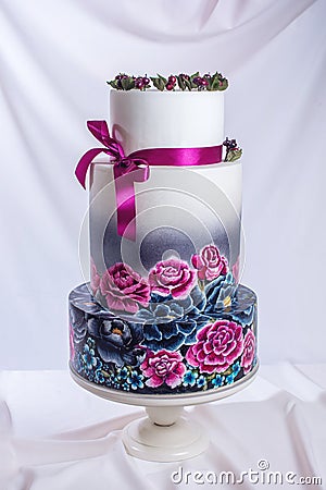 Wedding cake ornamented in rustic style blue and purple roses Stock Photo