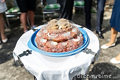 Wedding Cake raw ground pork cuisine burgers on tray with onion, rosemary and bread served on a wedding close-up Stock Photo