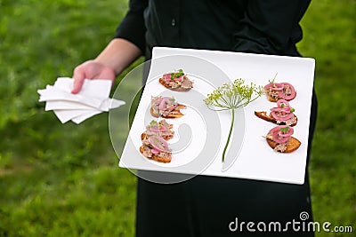 Wedding caterer carrying a plate of food Stock Photo