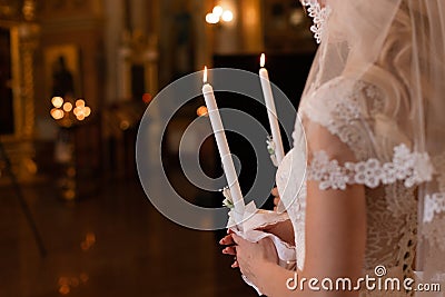 wedding ceremony. Church wedding. The bride is holding candles. White dress Stock Photo