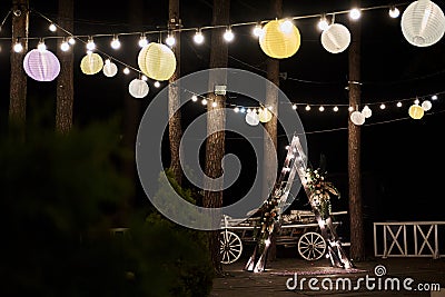 Wedding ceremony in the forest at night with Chinese lanterns. Stock Photo