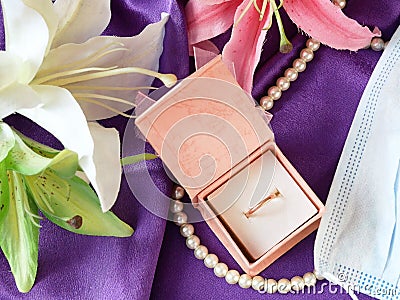 Wedding and coronavirus concept:jewelry box, blue medical mask, Stock Photo