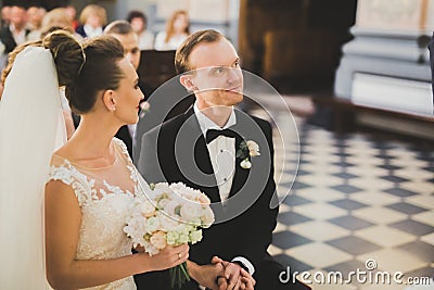 Wedding couple bide and groom get married in a church Stock Photo
