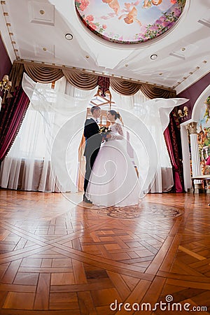 Wedding couple and curtains flying in the air Stock Photo