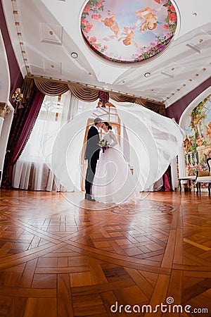 Wedding couple and curtains flying in the air Stock Photo