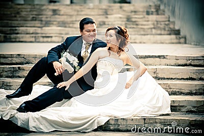 Wedding couple enjoying romantic moments outsides on a summer. Happy bride and groom on their wedding. Stock Photo