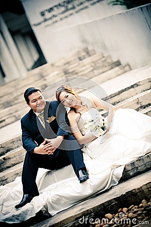 Wedding couple enjoying romantic moments outsides on a summer. Happy bride and groom on their wedding. Stock Photo