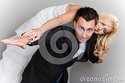 Wedding couple enjoying, woman on male back Stock Photo