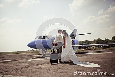 Wedding couple fly on honeymoon Stock Photo