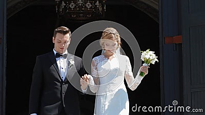 Wedding couple go out of the church after ceremony stock footage Wedding couple go out of the church after ceremony stock footage