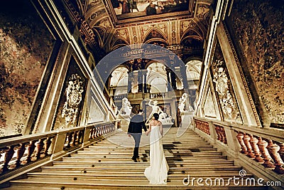 Wedding couple goes upstairs in an old theatre in Vienna Stock Photo