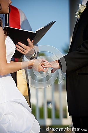 Wedding couple holding hands during the ceremony Stock Photo