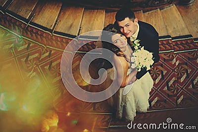 Wedding couple hugs each other and looks up Stock Photo