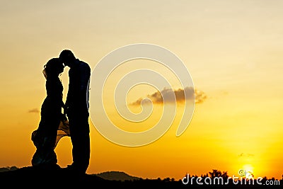 Wedding couple kissing with sunset Stock Photo