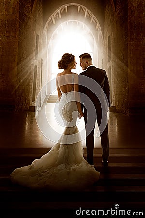 Wedding Couple in Love Back View walking down Aisle Church. Newly Wedded Bride Groom. Wedding Day Ceremony Stock Photo