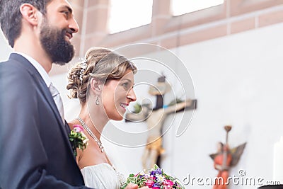 Wedding couple marrying in church Stock Photo