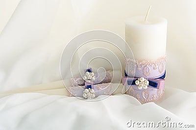 Wedding decorated candles with the bowknot and pearls in blue and violet colors Stock Photo