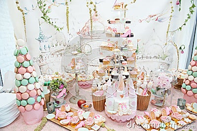 Wedding decoration with pastel colored cupcakes, meringues, muffins and macarons Stock Photo