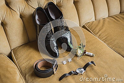 Wedding details. Groom accessories. Shoes, cufflinks, belt, watch, boutonniere Stock Photo