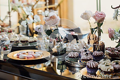 Wedding. Wedding details. Mr and Mrs. Delicious wedding reception candy bar table. Sweet holiday buffet with cupcakes Stock Photo