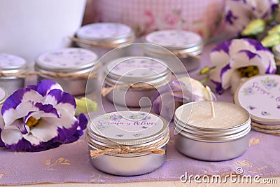 Wedding favors tin jar custom candles for party guests on favor purple table Stock Photo