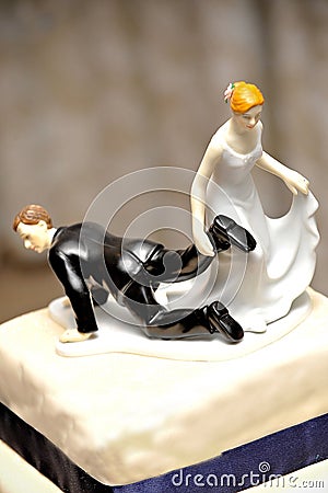 Wedding figurine with bride dragging the groom Stock Photo