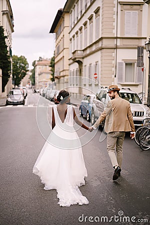 Interracial wedding couple. Wedding in Florence, Italy. African-American bride in a white dress and Caucasian groom in a Stock Photo
