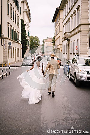 Wedding in Florence, Italy. Multiracial wedding couple. African-American bride in a white dress and Caucasian groom in a Stock Photo