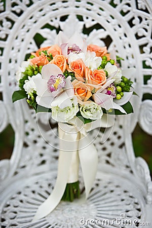 Wedding flower bouquet on a white garden chair Stock Photo