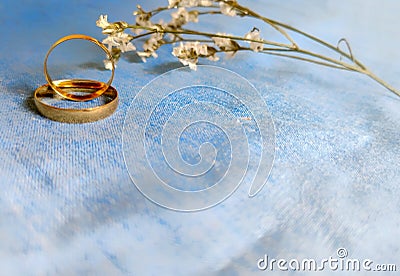 inspirational image of couple's rings with flower and denim jeans colour background Stock Photo