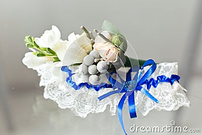 Wedding garter and boutonniere Stock Photo
