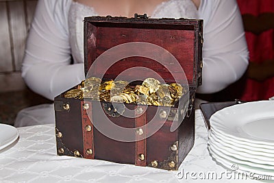 Wedding gift in form of a chest with a lot of golden coins 20 CZK. Editorial Stock Photo