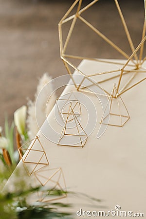 Wedding gold geometric decoration on the table Stock Photo