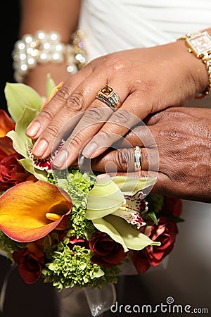 Wedding Hands and Rings on Tropical Bouquet Stock Photo